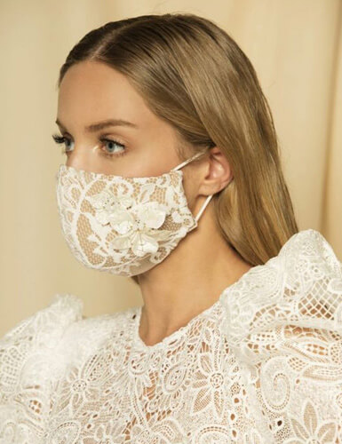 Bride wearing a white lace face mask